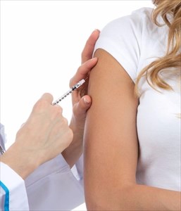 Young woman receiving flu vaccine.