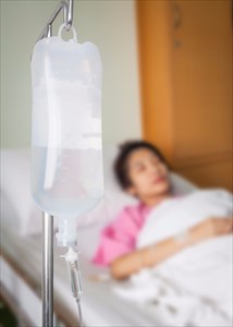 Woman receiving intravenous (IV) treatment in hospital.