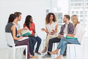 Therapist speaking to a group at a therapy session.