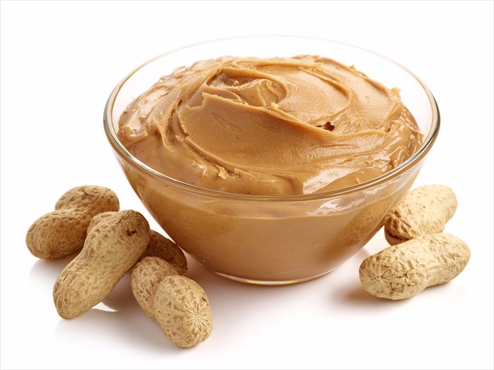 Bowl of peanut butter with peanuts