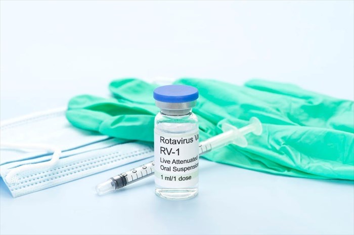 Rotavirus vaccine, gloves and syringe.