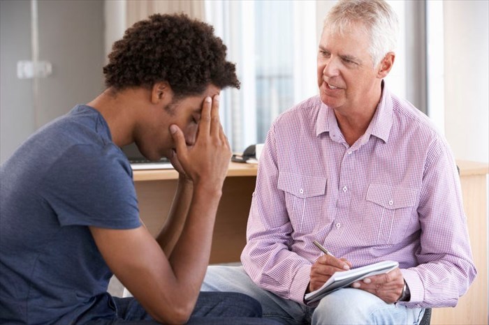 Man receiving counselling from psychologist. 