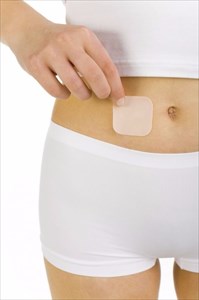 Woman using birth control patch.