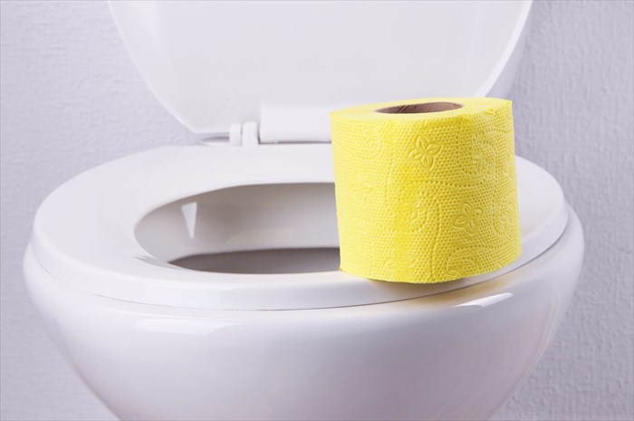 Toilet with yellow toilet paper