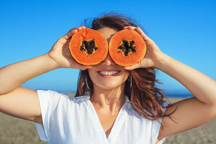 Women holding papaya