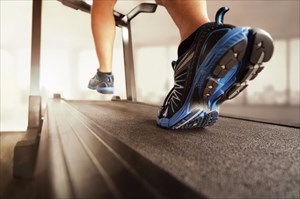 Young man running on the treadmill.