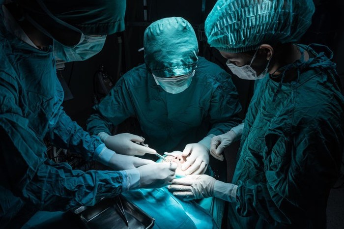 Surgery team operating in a surgical room.