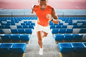Young man running up stairs (HIIT workout).