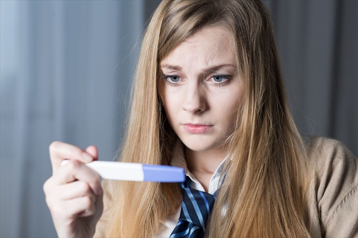 Teen girl with pregnancy test