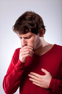 young man coughing with chest pain