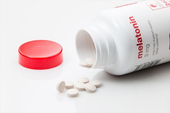 Close-up of melatonin tablets (open bottle)
