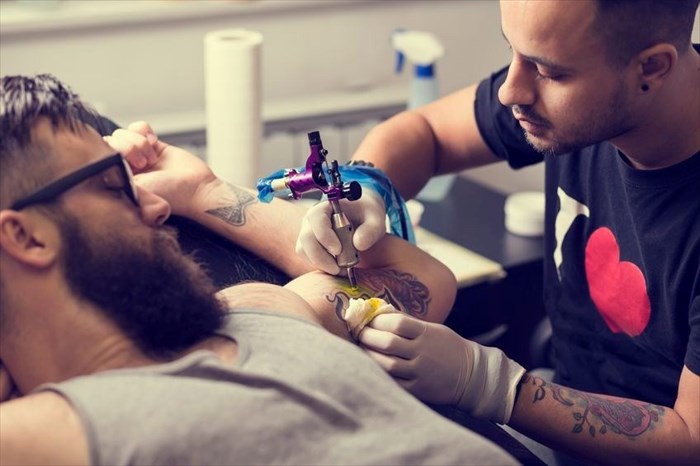 Guy getting tattoo