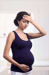 Young woman feeling unwell during pregnancy