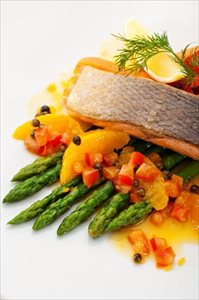 Salmon steak with fruits, vegetables, asparagus and lemon