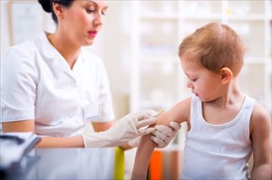 Medical doctor administers MMR vaccination to young child.
