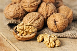 Walnuts on wooden surface.