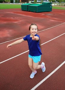 Little girl with down syndrome enjoying being active.