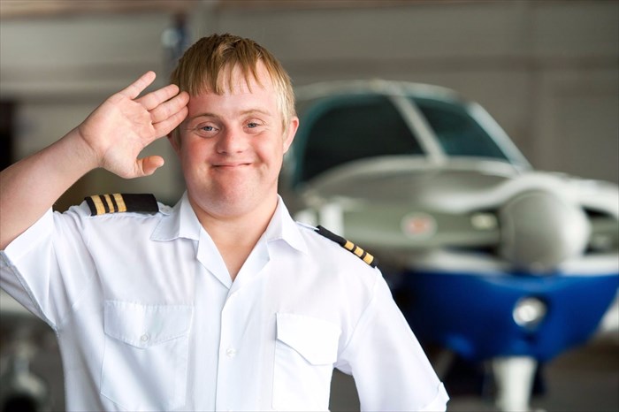 Young man with down syndrome working as a pilot.